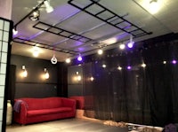 a room with a red couch and purple lights